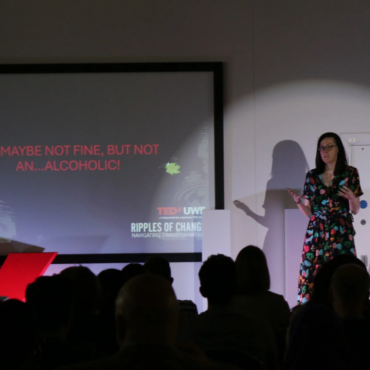 Clare E Kenny speaking about alcoholism on the TEDx stage