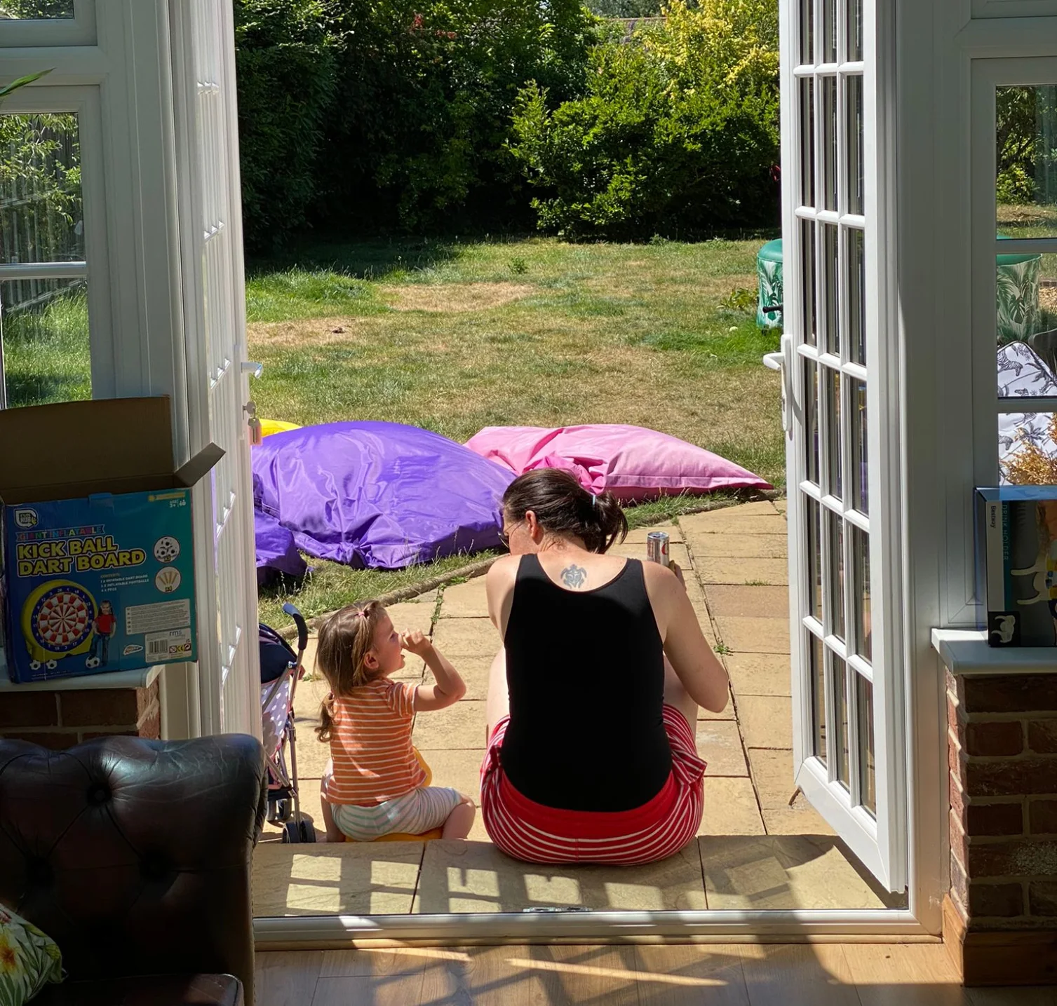 Clare E Kenny sitting in the garden with her daughter